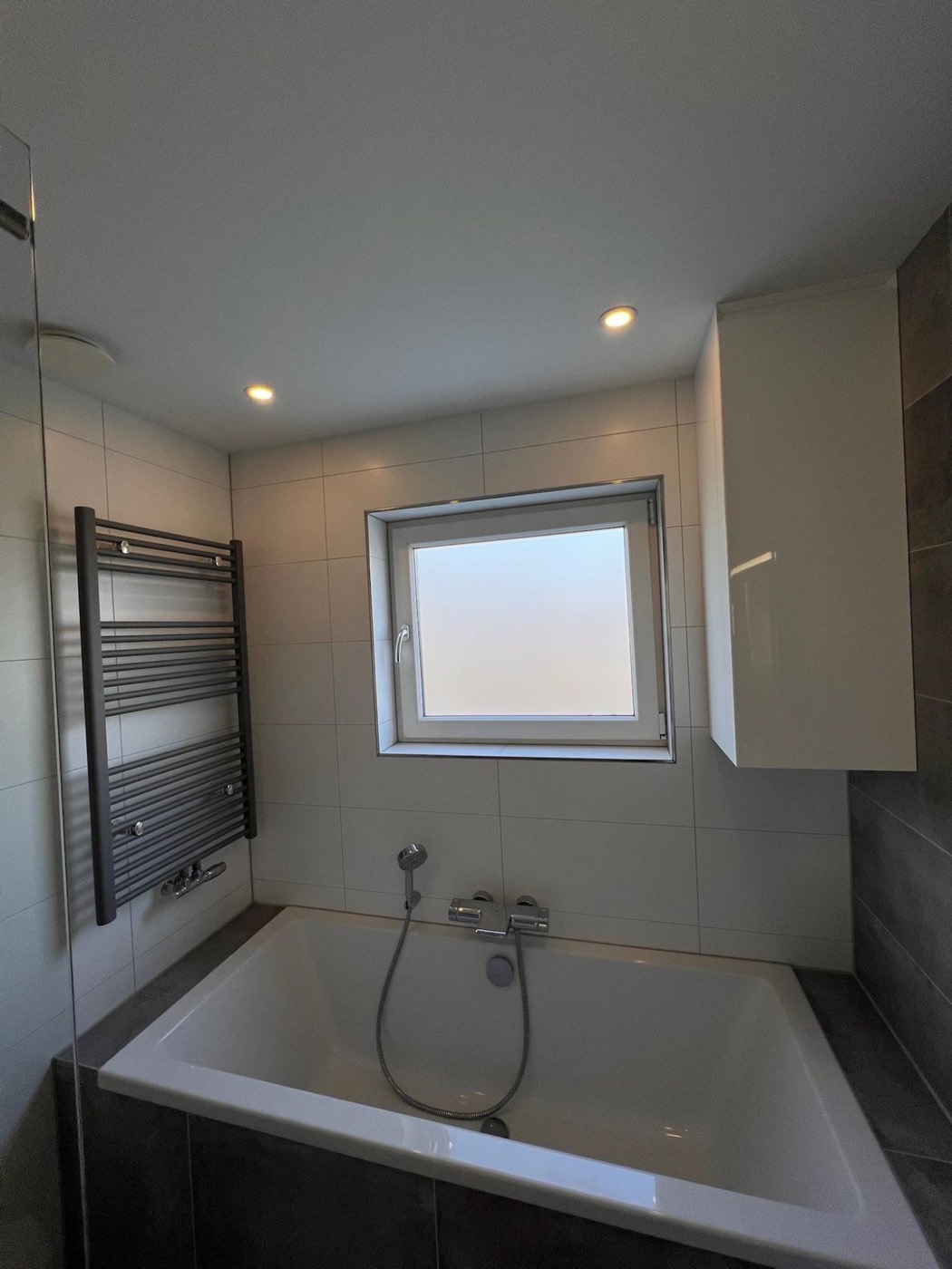 Ligbad met handdoekradiator en raam